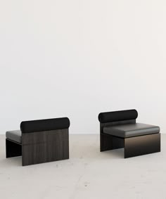 two black benches sitting next to each other