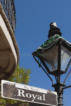 a lamp post with a street sign attached to it