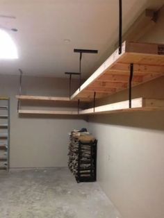 an empty room with shelves and ladders in it