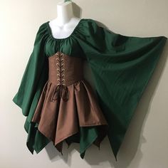 a green and brown dress is hanging on the wall