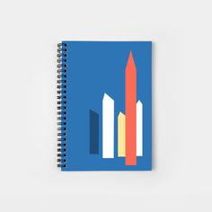 a spiral notebook with an image of buildings on it