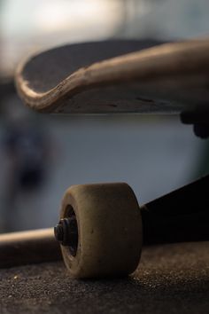 black and white photograph of a skateboard on the ground with its wheels still attached