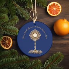 an ornament hanging from a christmas tree next to oranges