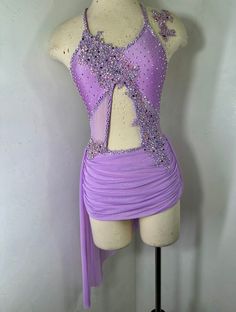 a female figure in a purple dress on a mannequin