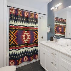 a bathroom with blue walls and white cabinets