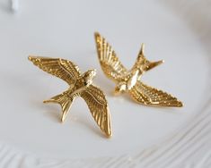 Beautiful and high quality gold swallow studs. Simply, bold, and elegant. There is no need more words to describe how pretty it is. Let this unique earrings be a perfect accessory for your special day or can be a wonderful gift to your loved one. Because each item is handmade there may be differences from the picture viewed. Each stone/ piece is unique and no two pieces will be exactly alike.  Question? Please contact me or let me know in the "Note" section at checkout.  Please be sure to read o Bee Inspired, More Words, Words To Describe, Pretty Jewellery, Unique Earrings, Shop Policies, Jewelry Earrings Studs, Two Pieces, To Read