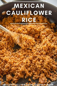 mexican cauliflower rice in a skillet with a wooden spoon on the side