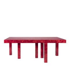 a red table sitting on top of a white floor