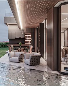 an outdoor living room and dining area with water running through the floor to the pool