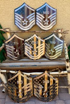 an old wooden bench with metal shield emblems on it's back and sides