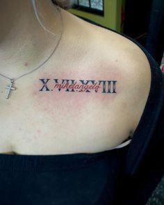 a woman with a cross tattoo on her chest that says x, y and all