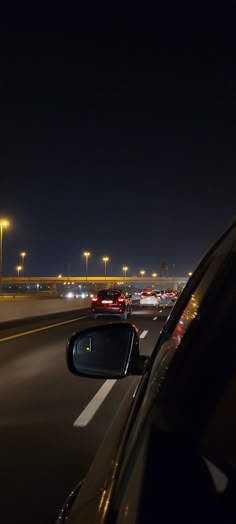 cars driving down the highway at night time