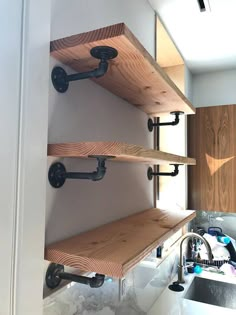 the shelves are made out of wood and have metal fittings on each shelf,