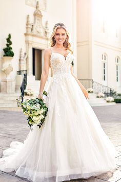 a woman in a white wedding dress holding a bouquet