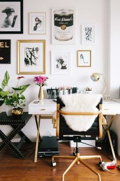 a white desk with lots of pictures on the wall