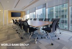 an empty conference room with black chairs and a flat screen tv