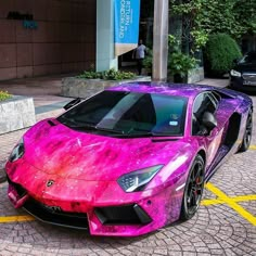 a pink and purple car parked on the street