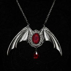 Immortal Necklace Limited Edition Beautiful vampire themed necklace with central red stone on bat wing base with hanging blood drop on a stainless steel chain.  Handmade to order; ready in 3-4 days. May take longer during busy times. Red Goth Jewelry, Gothic Pendant Necklace For Halloween, Halloween Gothic Pendant Jewelry, Halloween Gothic Pendant Necklace, Gothic Winged Jewelry Gift, Gothic Winged Jewelry For Gifts, Vampire Style Necklaces For Halloween Cosplay, Gothic Halloween Costume Necklace, Gothic Jewelry For Halloween Costume