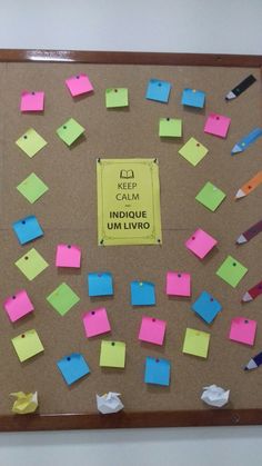 a bulletin board with sticky notes attached to it