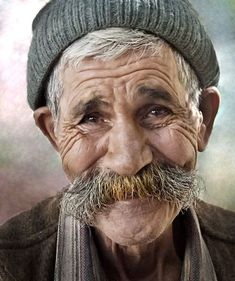 black and white photograph of an old man with a beard wearing a knitted hat