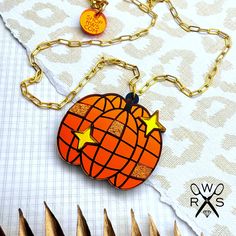 Get ready to boogie all night long with our Disco Pumpkin Necklace! Part of our Summerween Collection, this laser cut acrylic, shiny necklace features a disco ball pumpkin dancing under the moonlight. Add some pizzazz and glitz to your Halloween party with this quirky necklace. (Disco dancing skills not included!) ◾ laser cut acrylic, stainless steel and hypoallergenic ◾ 1.5" tall, 1.75" wide, 18" gold tone paperclip chain with lobster clasp ◾ Flat Rate Shipping ◾ Free shipping on domestic orders $35+ 70s Jewelry Disco, Disco Necklaces, Disco Ball Pumpkin, Pumpkin Dance, Dancing Under The Moonlight, Quirky Necklace, Shiny Necklace, Disco Pumpkin, Spooky Orange Halloween Jewelry