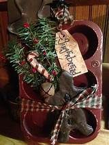 a wooden sleigh with christmas decorations and an ornament on it's side