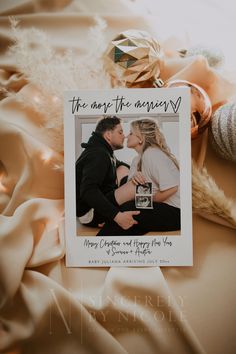 an engagement photo on top of a christmas ornament next to other ornaments and decorations