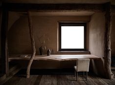 a wooden table sitting next to a window in a room