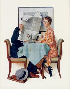 a man and woman sitting at a table reading the paper