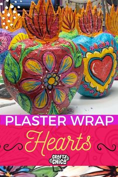 some colorful vases with flowers painted on them and the words, plastic wrap hearts