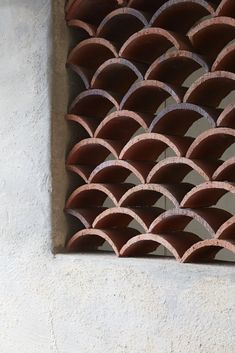 a cat is sitting on the ledge of a building with an arched window in it