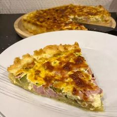 a slice of ham and cheese quiche sits on a plate next to the rest of the pie