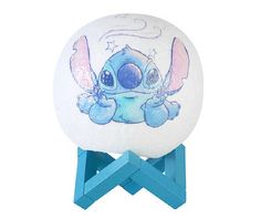 a white and blue night light with an image of stitchy in the sky on it