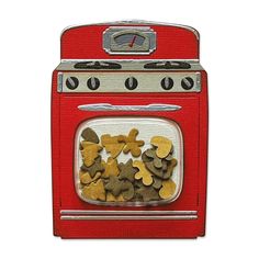 a red stove top oven sitting next to a pile of cut up dog bones on it's side