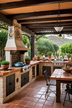 the outdoor kitchen has an oven, table and chairs