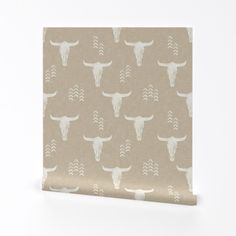 a beige wallpaper with white steer heads on it