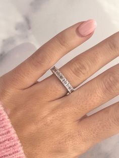 a woman's hand with a diamond ring on it