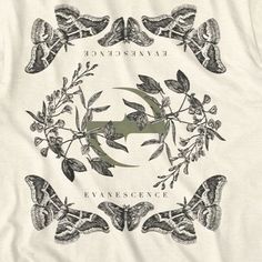 a white t - shirt with an image of moths and leaves in the shape of a crescent