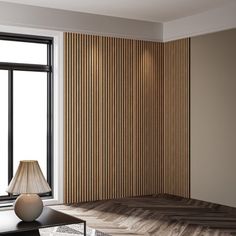 a living room with a couch, table and lamp next to a large window that has vertical blinds on it