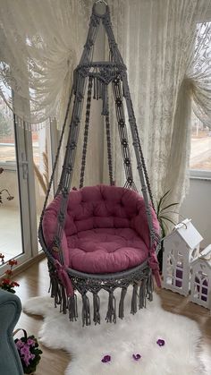 a hanging chair in the middle of a room with white fur rugs on the floor