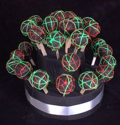 a black cake with green and red lights on it