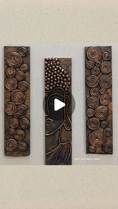 three wooden plaques with designs on them and one has a video player in the middle