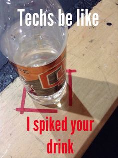 a glass that is sitting on top of a table with tape around it and the words techs be like i spoked your drink