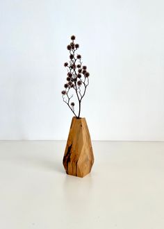 a small wooden vase with flowers in it