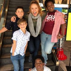 a group of people that are standing on some stairs together and posing for the camera