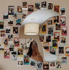 a woman taking a selfie in front of a mirror with pictures on the wall