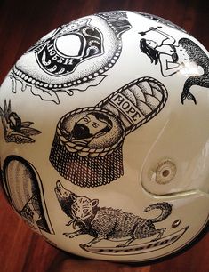 the helmet is decorated with images of cats and other animals on it's side