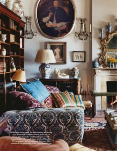 a living room filled with furniture and a painting on the wall above it's fireplace