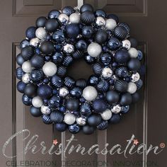 a blue and white christmas ornament wreath on a door