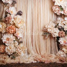 an arrangement of flowers arranged on the wall in front of a sheer fabric backdrop with text overlay